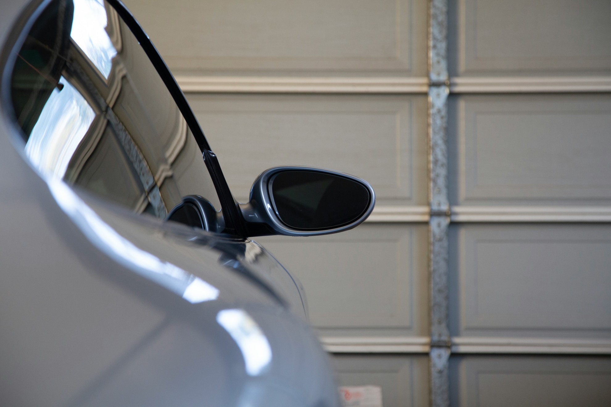 image of a car in a garage for a garage door repairs blog